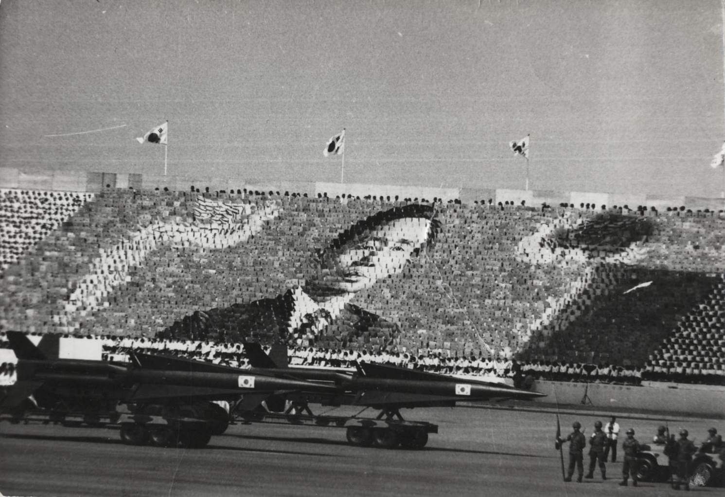 South Korean Army parade at Armed Forces Day in 1973. A huge Card stunt which is honoring Park Chung-hee is being performed.