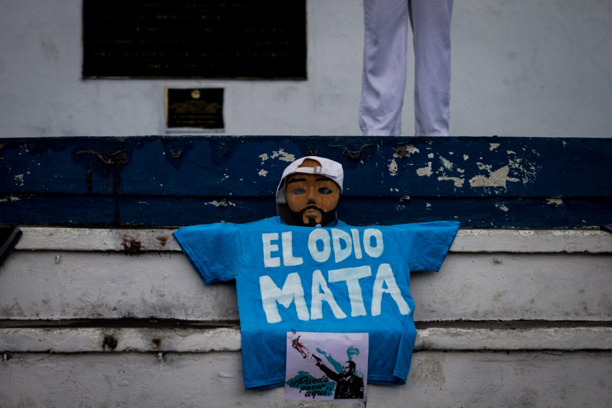 "Hate kills" written on a shirt placed below a mask representing Nayib Bukele's face during the 2021 protests in El Salvador.