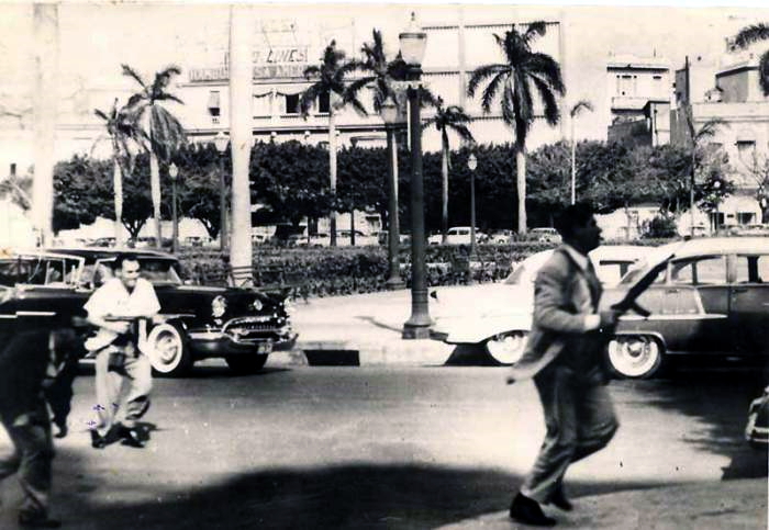 Armed DR militants advancing through the streets during the attack at the Havana Presidential Palace attack.