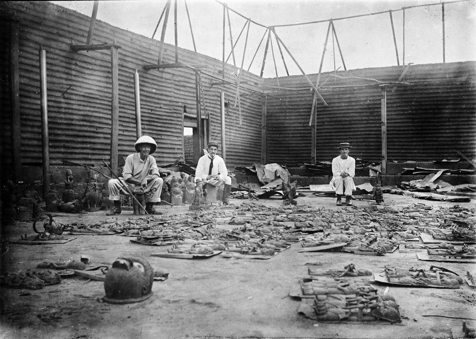 A photograph of the interior of Oba's palace during the punitive expedition, with the looted Benin Bronzes in the foreground, 1897.