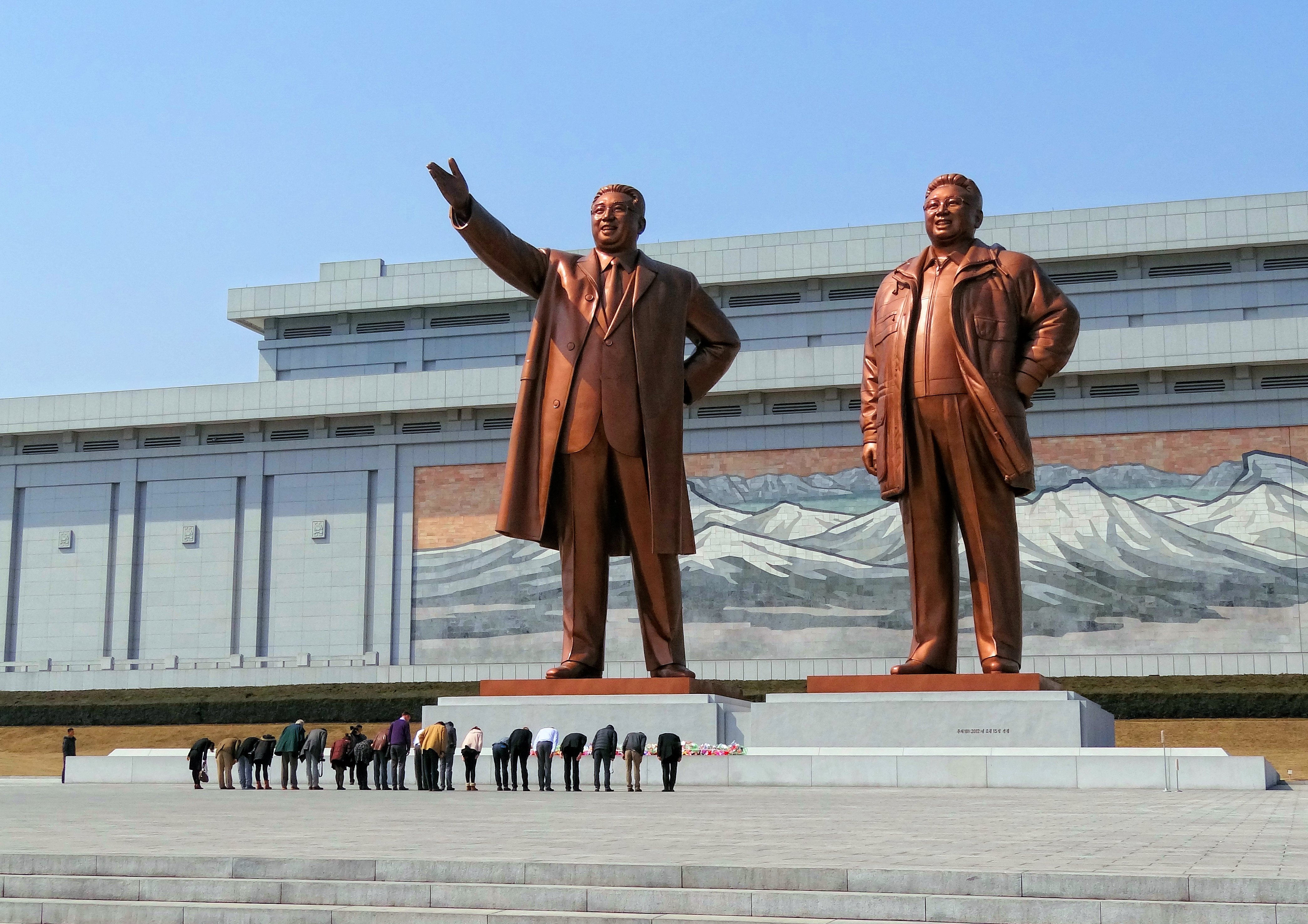 Visitors bowing before statues of North Korean leaders Kim Il-sung and Kim Jong-il in Pyongyang, North Korea, 2014.