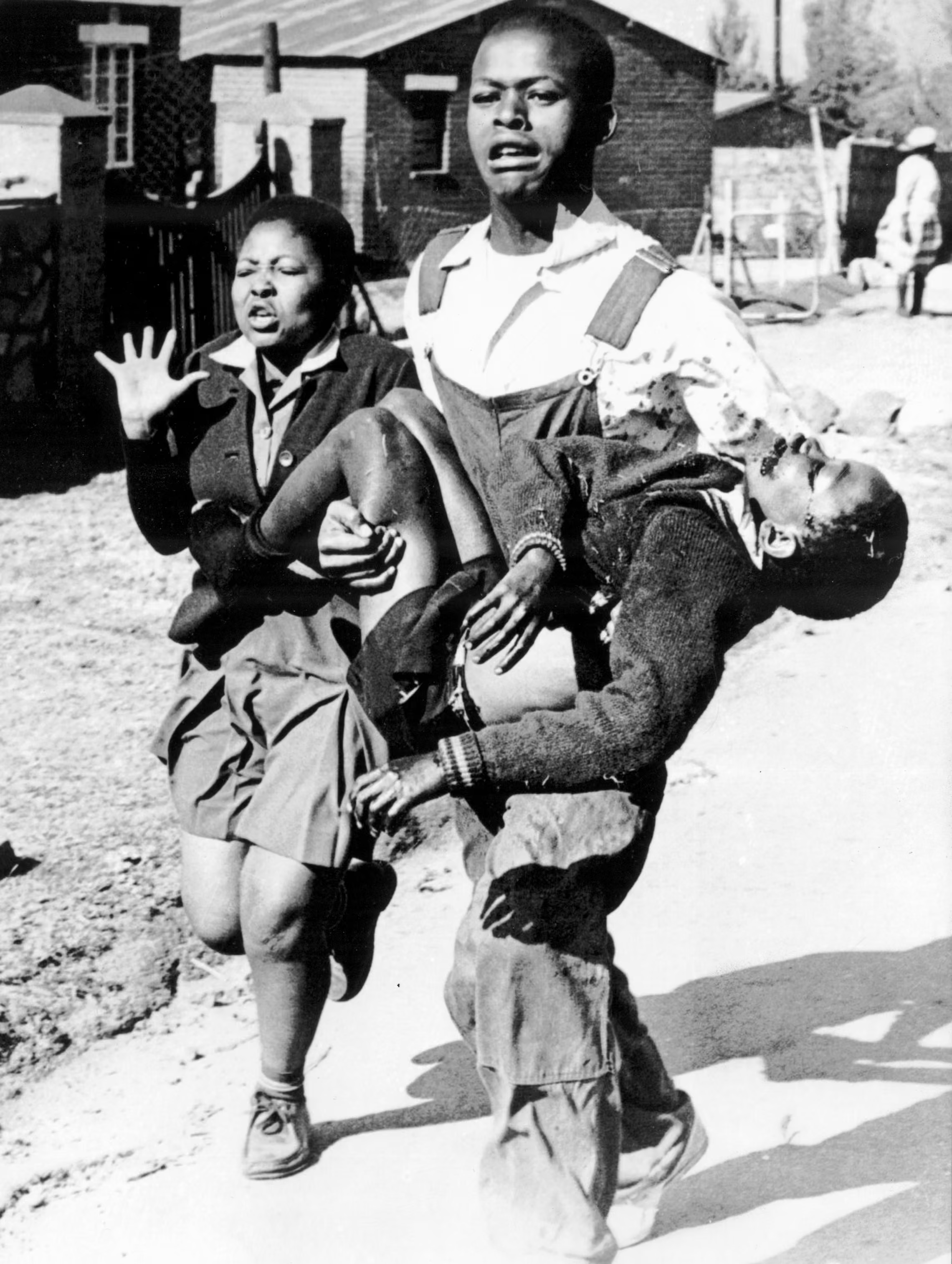Mbuyisa Makhubu carries Hector Pieterson after Pieterson was shot and killed at the Soweto Uprising. Antoinette Sithol, Pieterson's sister, runs beside them.