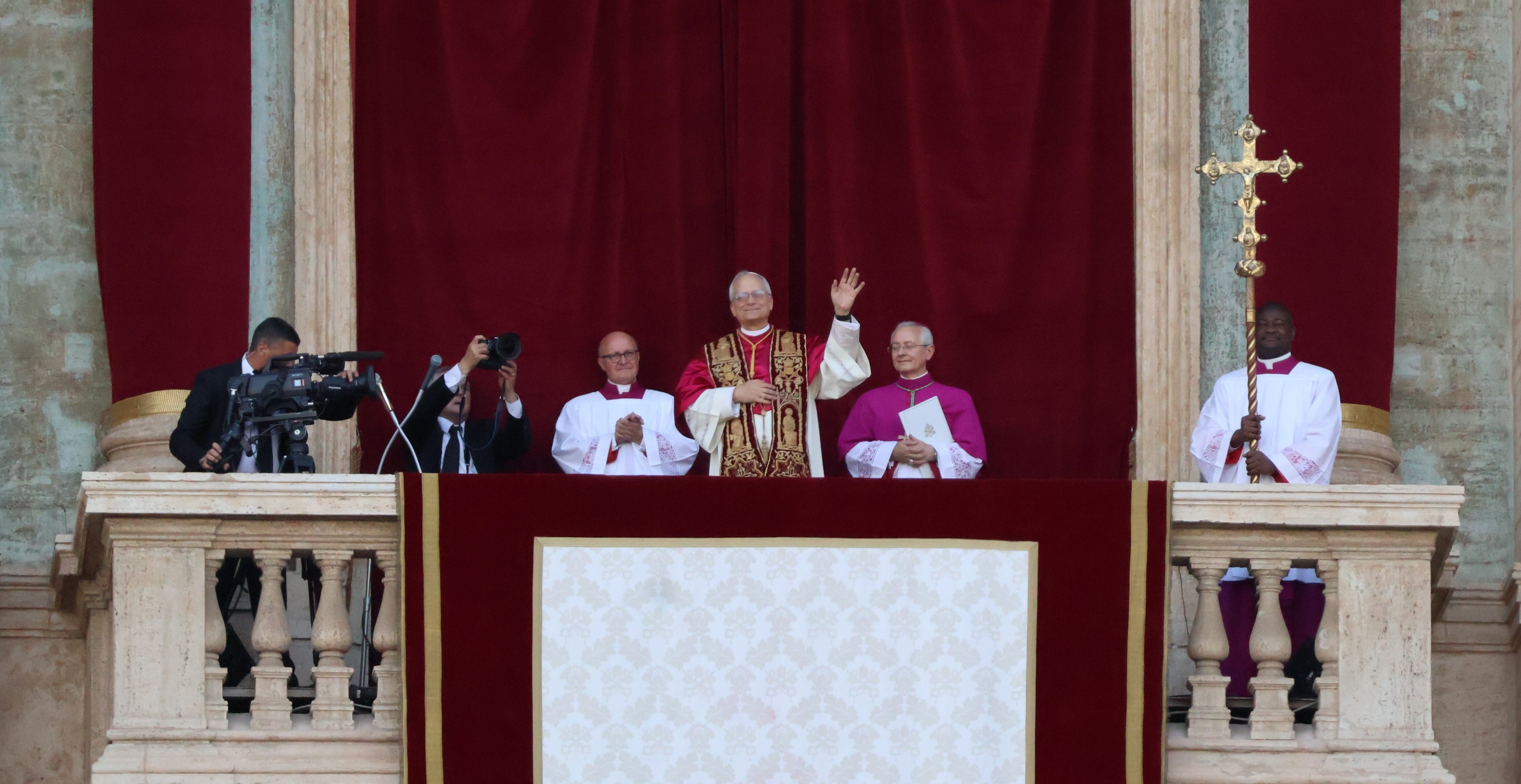 Pope Leo XIV waving from the balcony of St. Peter's Basilica in his first public appearance, 2025.