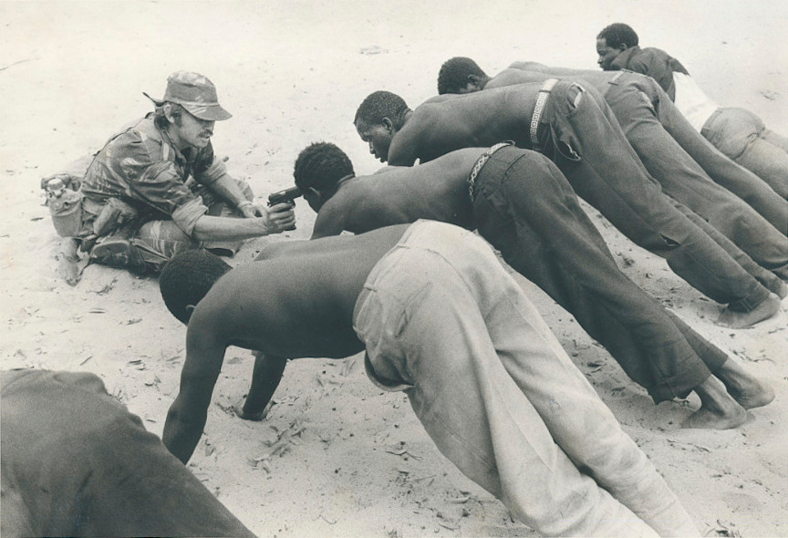 A Rhodesian soldier questioning villagers near the border of Botswana in 1977.