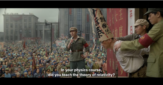 Ye Zhetai’s public trial during the Cultural Revolution. Ye is held down by two students on the right. He is wearing a dunce cap on which his name is crossed out in red to indicate his suspect political status. Screenshot from 3 Body Problem on Netflix.