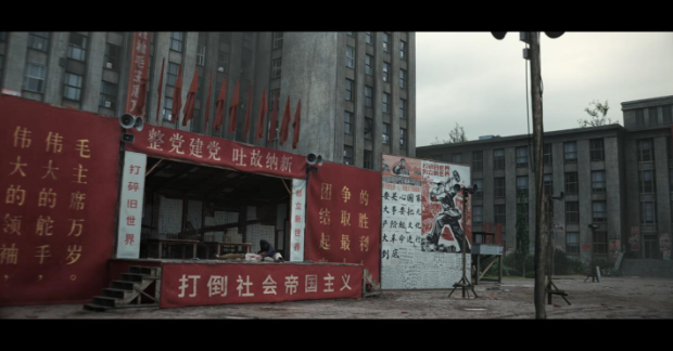 The slogan on the bottom of the stage reads: “Overthrown Socialist Imperialism.” Screenshot from 3 Body Problem on Netflix.