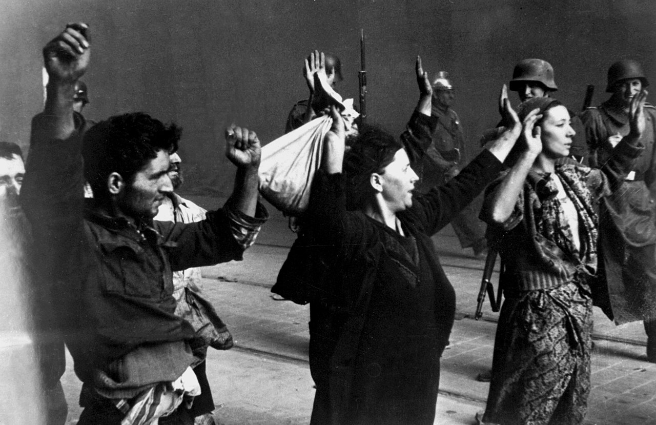 German soldiers detain Jewish resistors during the Warsaw Ghetto Uprising, 1943.
