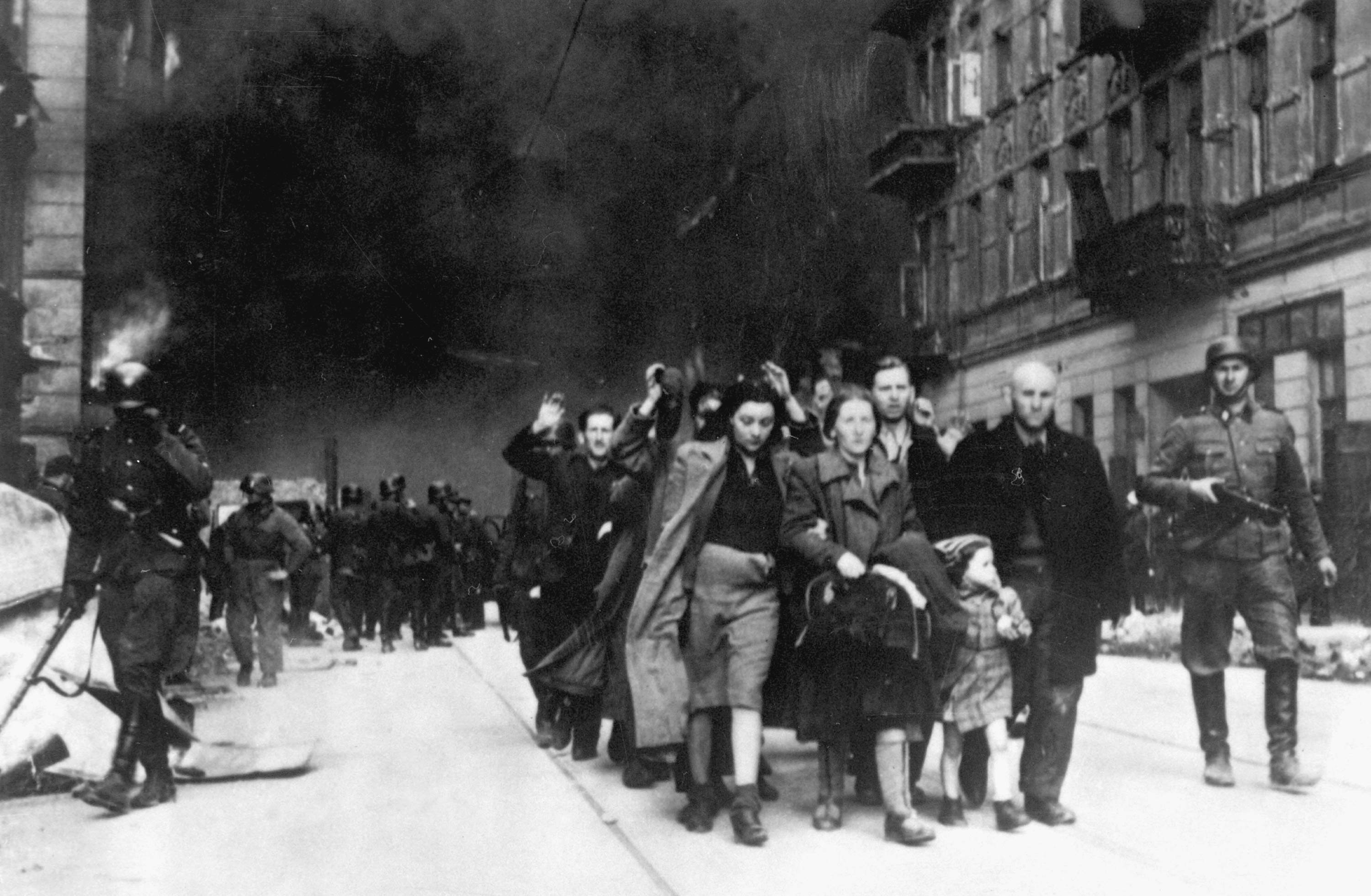 German troops lead captured Jewish residents of the Warsaw Ghetto to the assembly point for deportation, 1943.