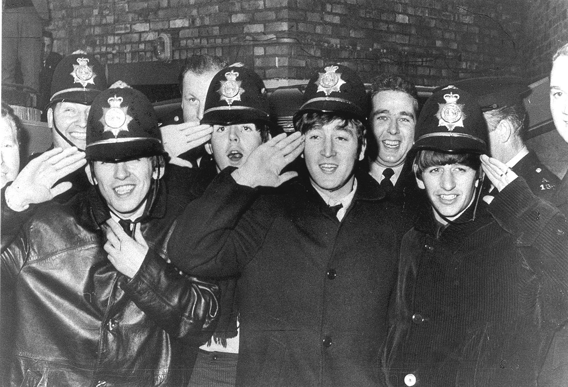 The Beatles outside the Birmingham Hippodrome, November 1963. Due to the size of the crowds, they had to be smuggled into the venue with assistance from local police.