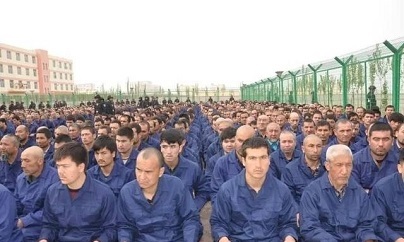 Detainees in a Xinjiang Re-education Camp listening to "de-radicalization" talks, 2018.