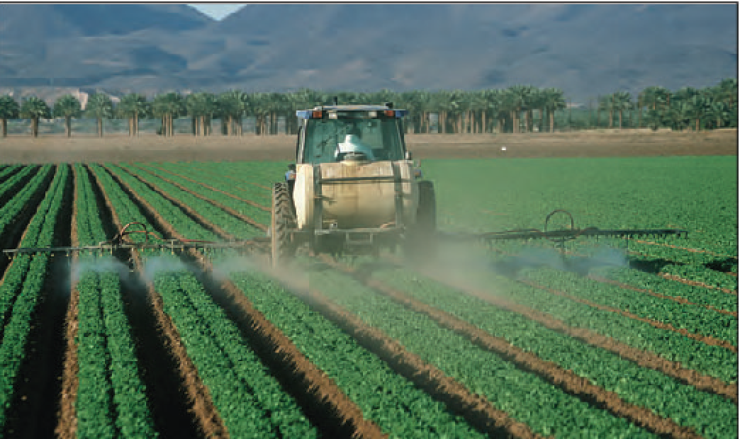 A grower disperses pesticides over low-growing row crops. United States Geological Survey. 