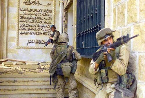 Marines enter one of Saddam Hussein’s palaces on April 9, 2003.