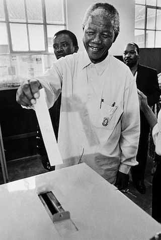 Mandela casting his ballot for the first time in his life in 1994