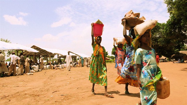 Darfur refugees carrying food home from a World Food Program center in 2007.