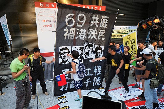 Hong Kong protesters in 2018 splashing ink onto portraits.