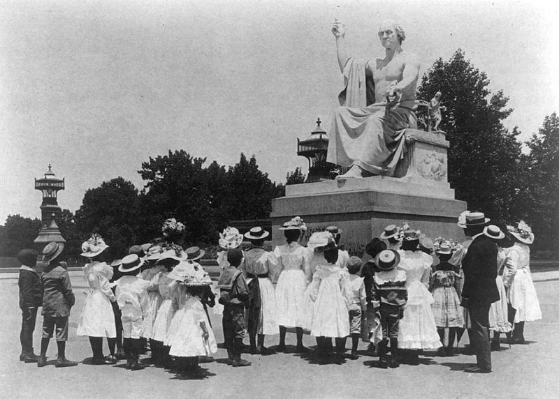 Black schoolchildren in front of the Horatio Greenough statue of George Washington in Washington, D.C. around 1899.