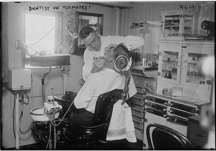A dentist and patient in the 1910s or 1920s