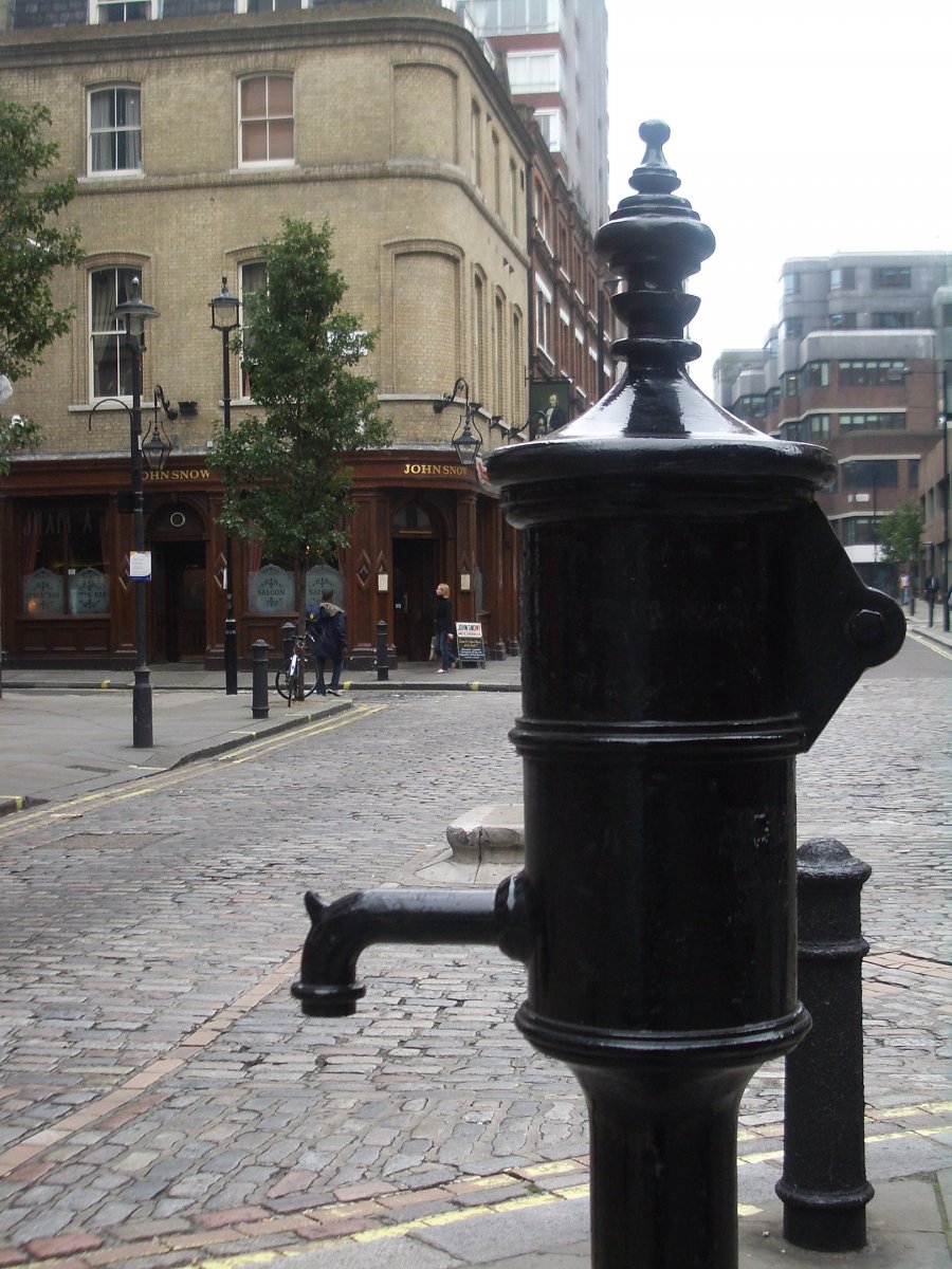 The pump in the foreground serves as the John Snow memorial and is modeled after the original Broad Street pump.