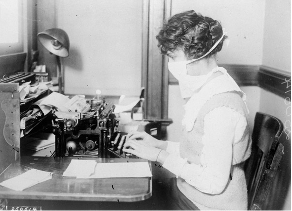 A typist with cloth mask during the influenza pandemic in 1918.