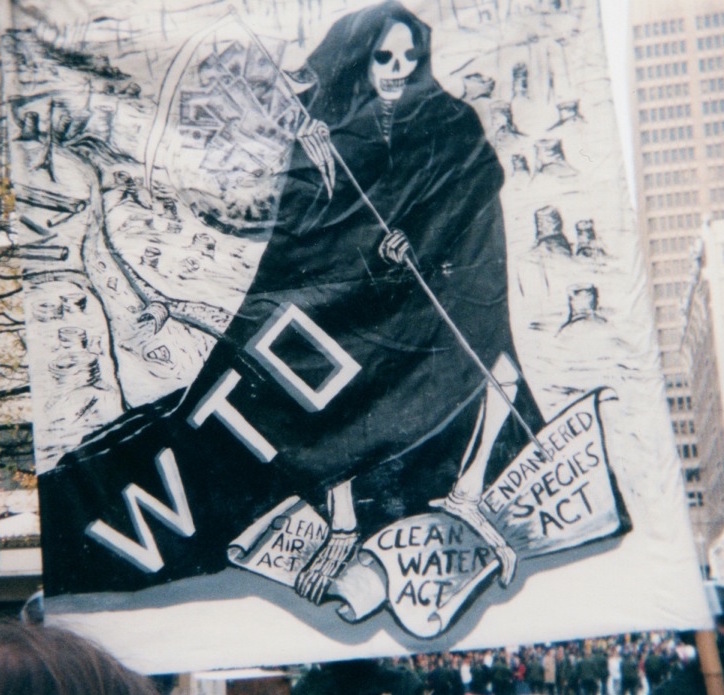 A sign from the 1999 WTO protests in Seattle, Washington depicting the WTO as the Grimm Reaper.