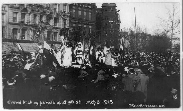 The Suffrage Parade surrounded by crowds at 9th Street.
