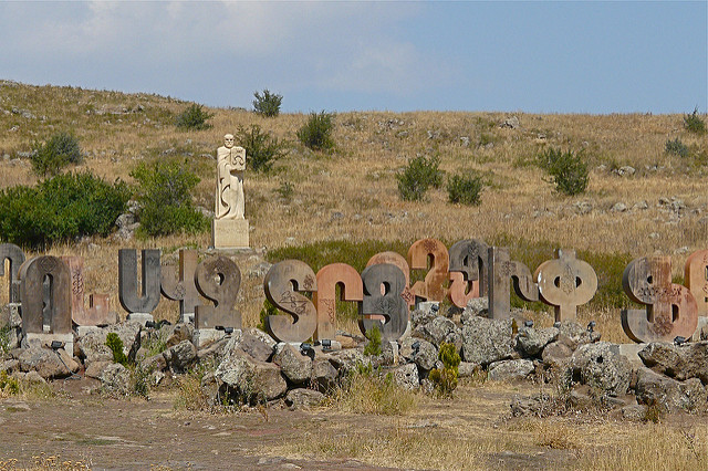 Stone carvings of the Armenian alphabet in front of a statue of the alphabet’s creator.