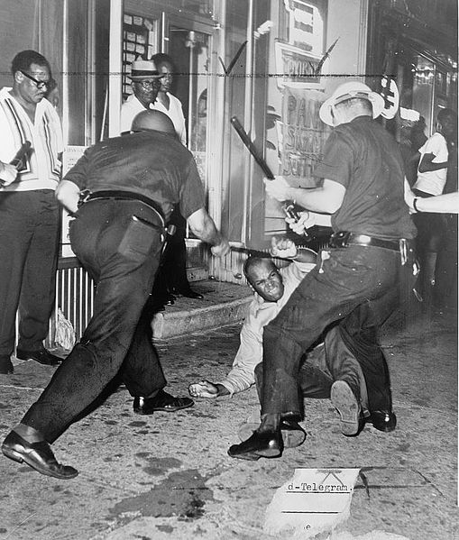 Police confront a demonstrator during the Harlem Riots of 1964.