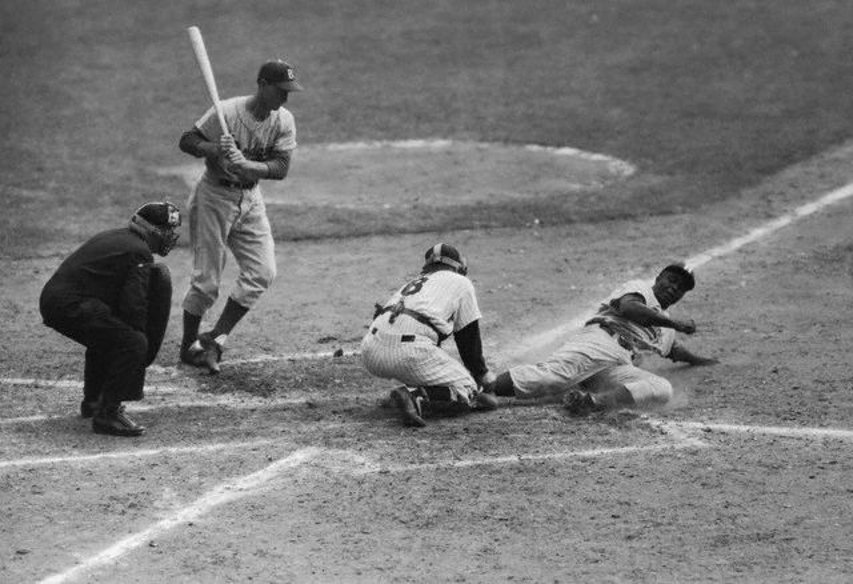 Jackie Robinson stealing home in the 1955 World Series.