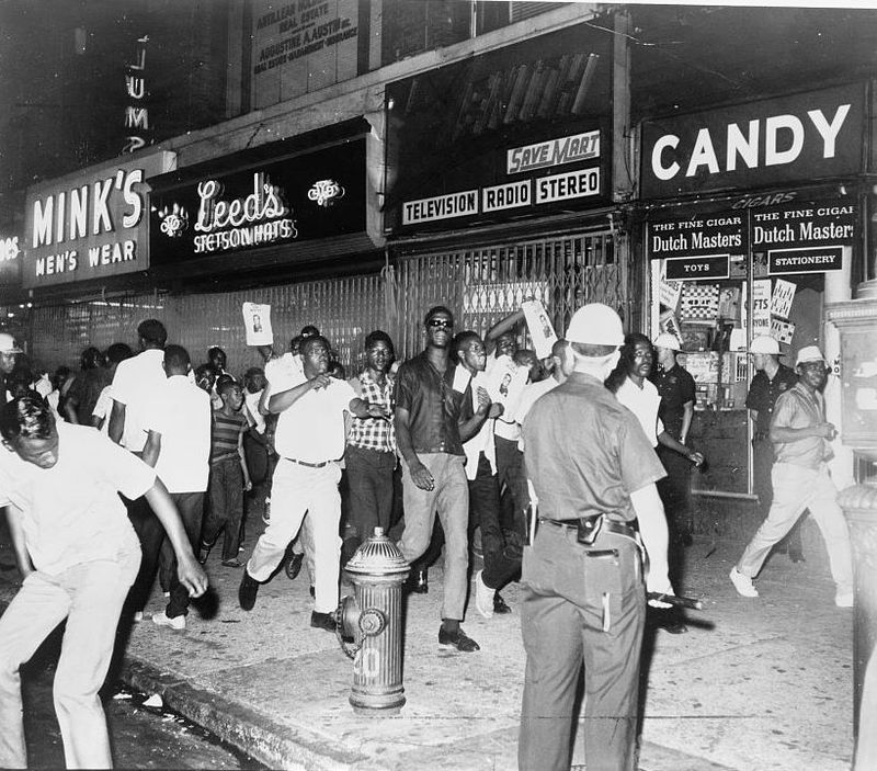 During the Harlem Riots of 1964, demonstrators carry leaflets of Lieutenant Thomas Gilligan who shot and killed 15-year-old James Powell, a black student.