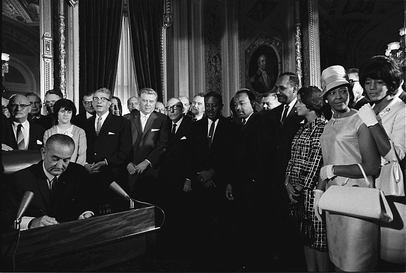 Lyndon B. Johnson signs the Voting Rights Act of 1965.