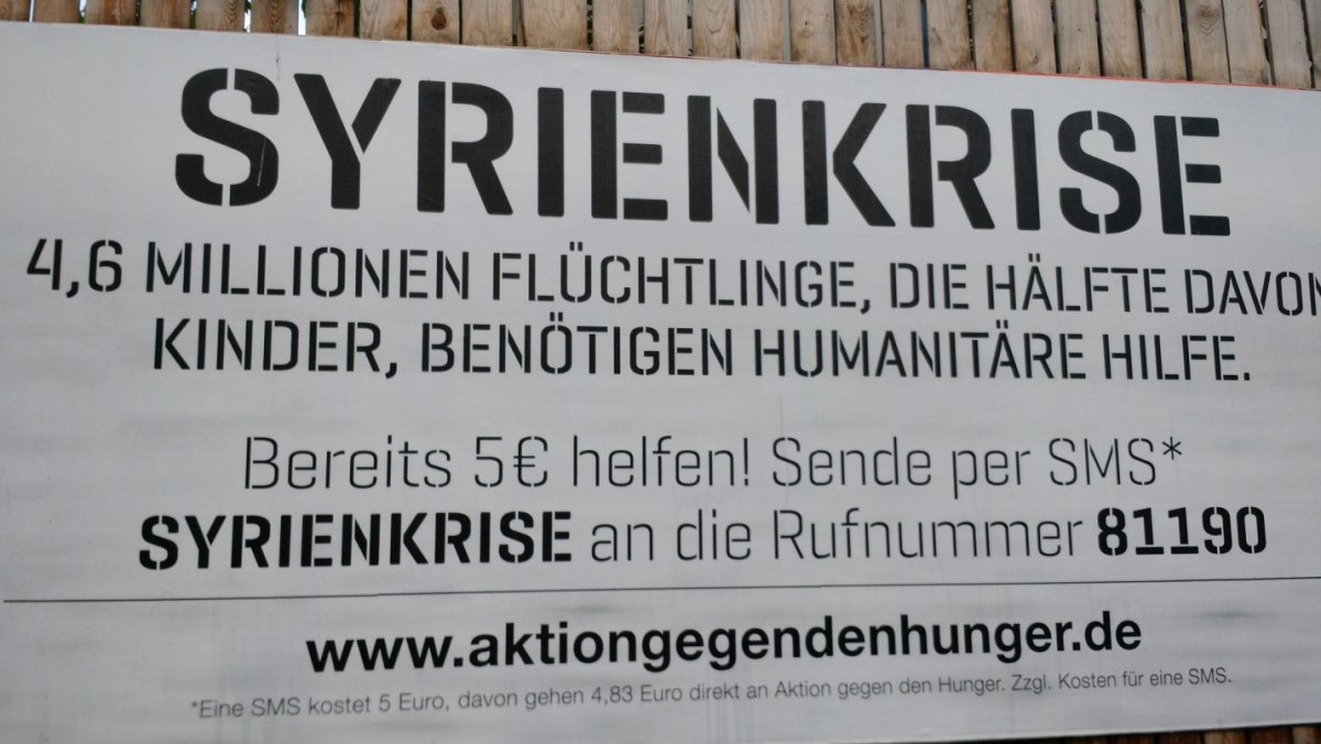 A sign urges Berliners to donate in order to help feed Syrian refugees.