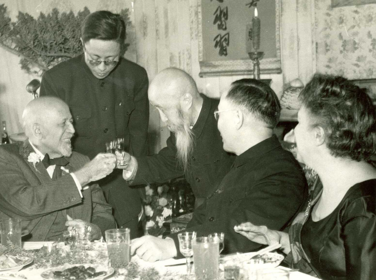 Chinese officials toast W. E. B. Du Bois at a celebration of his 91st birthday.