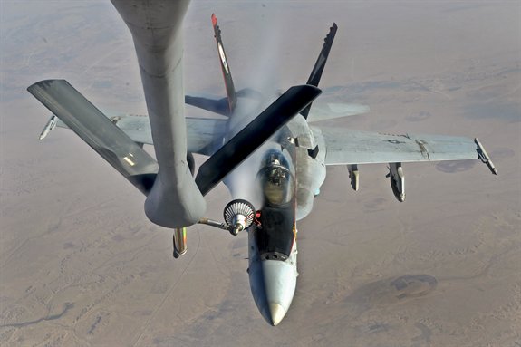 A U.S. Navy F-18E Super Hornet receives fuel from a KC-135 Stratotanker over Iraq.
