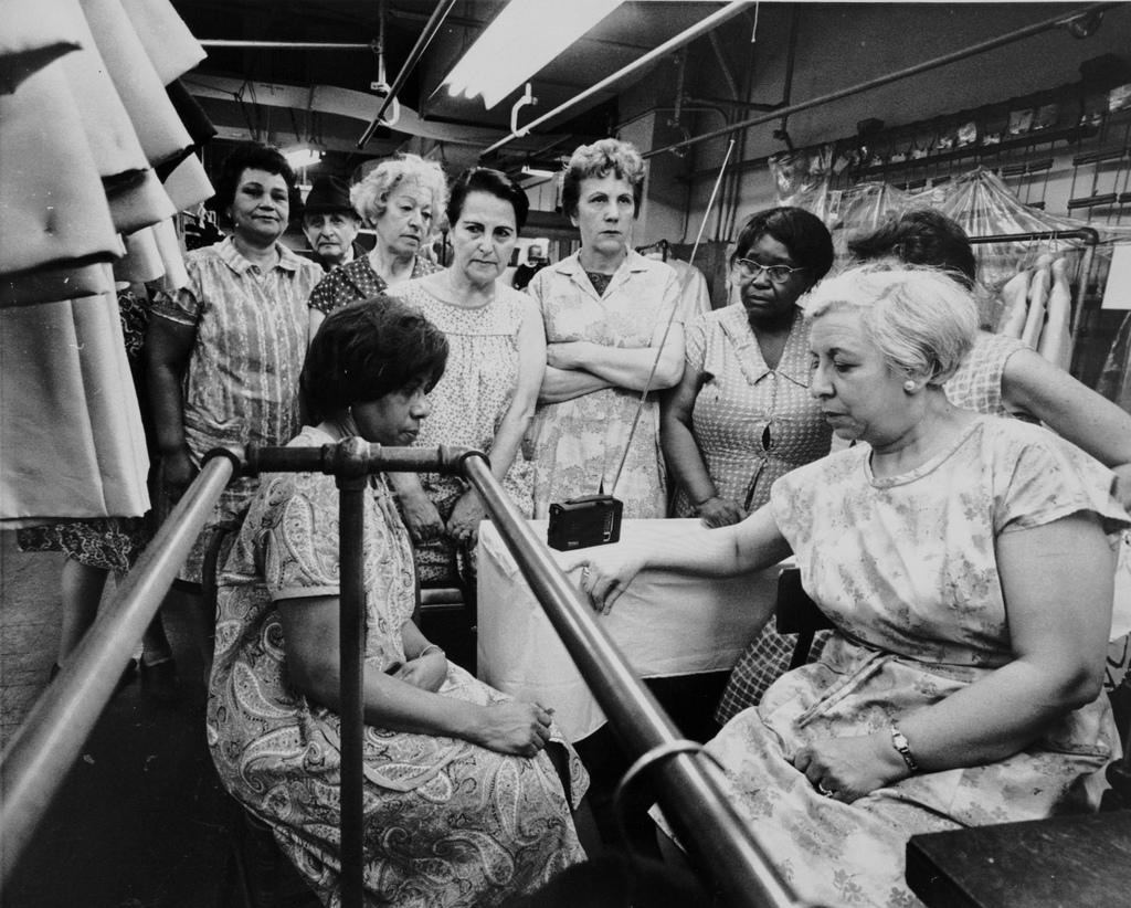 Garment workers listen to the funeral service for Dr. Martin Luther King, Jr. on radio, April 1968.