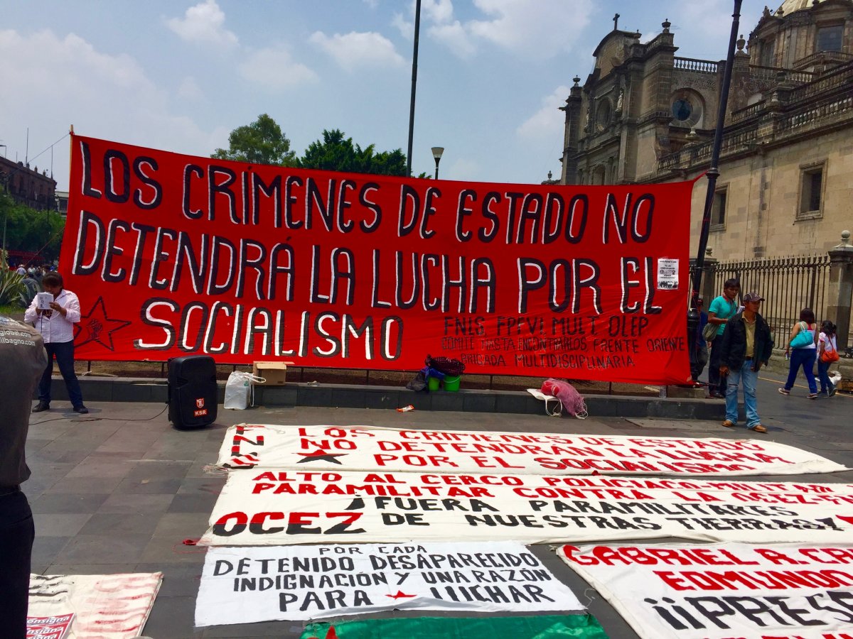This sign states: 'The crimes of the state will not stop the fight for socialism.'