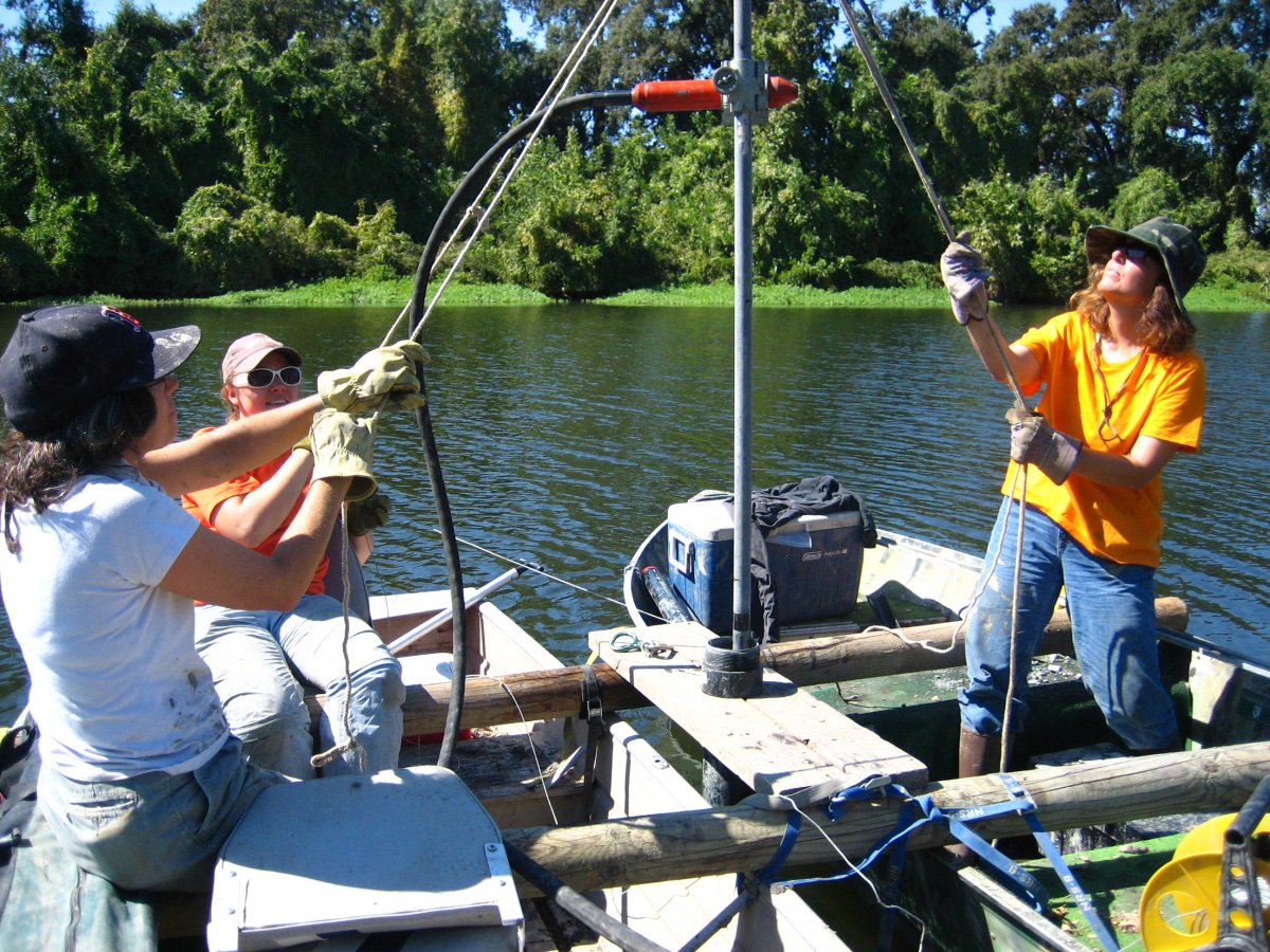 Frances Malamud-Roam, B. Lynn Ingram, and Christina Brady coring a small oxbow lake in the Sacramento Valley, California.