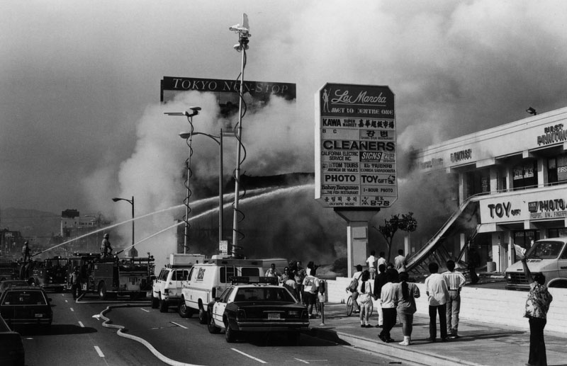 Fire fighters attempt to put out the burning La Mancha shopping center, 1992.