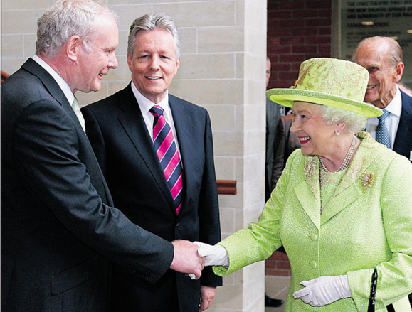 Queen Elizabeth II and Martin McGuiness shake hands.