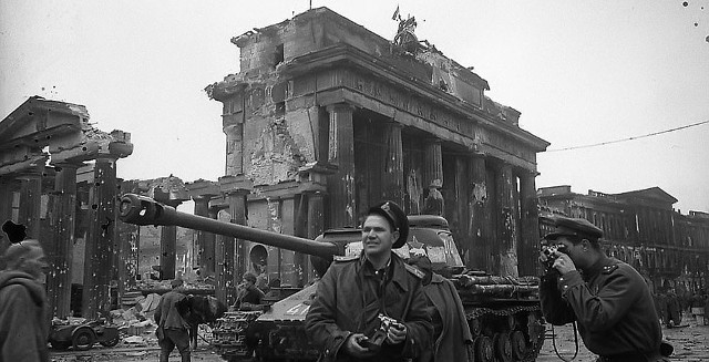 Soviet Army photographer Yevgeny Khaldei in Berlin, Germany, May 1945 with the Brandenburg Gate in the background.