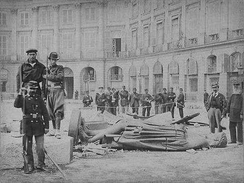 Communards pose with the toppled statue of Napoleon I in the Place Vendôme in 1871.