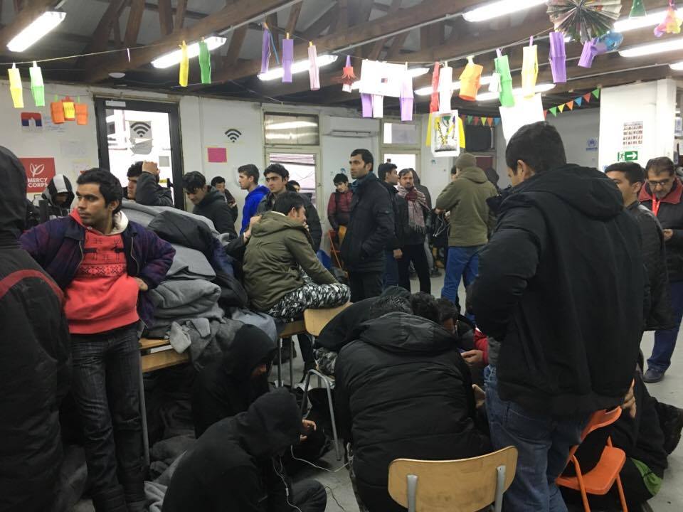 Refugees in Miksaliste warming up, charging their phones, and using Wi-Fi.