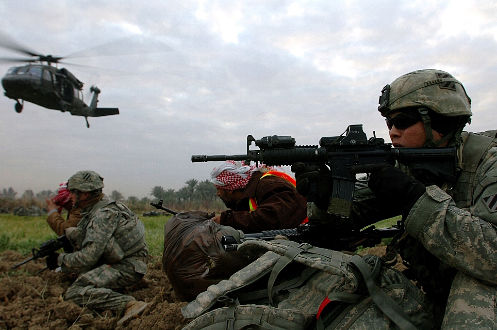 U.S. Army Private First Class Kenneth Armbrister scans for enemy activity during surge operations in Arab Jabour, Iraq.