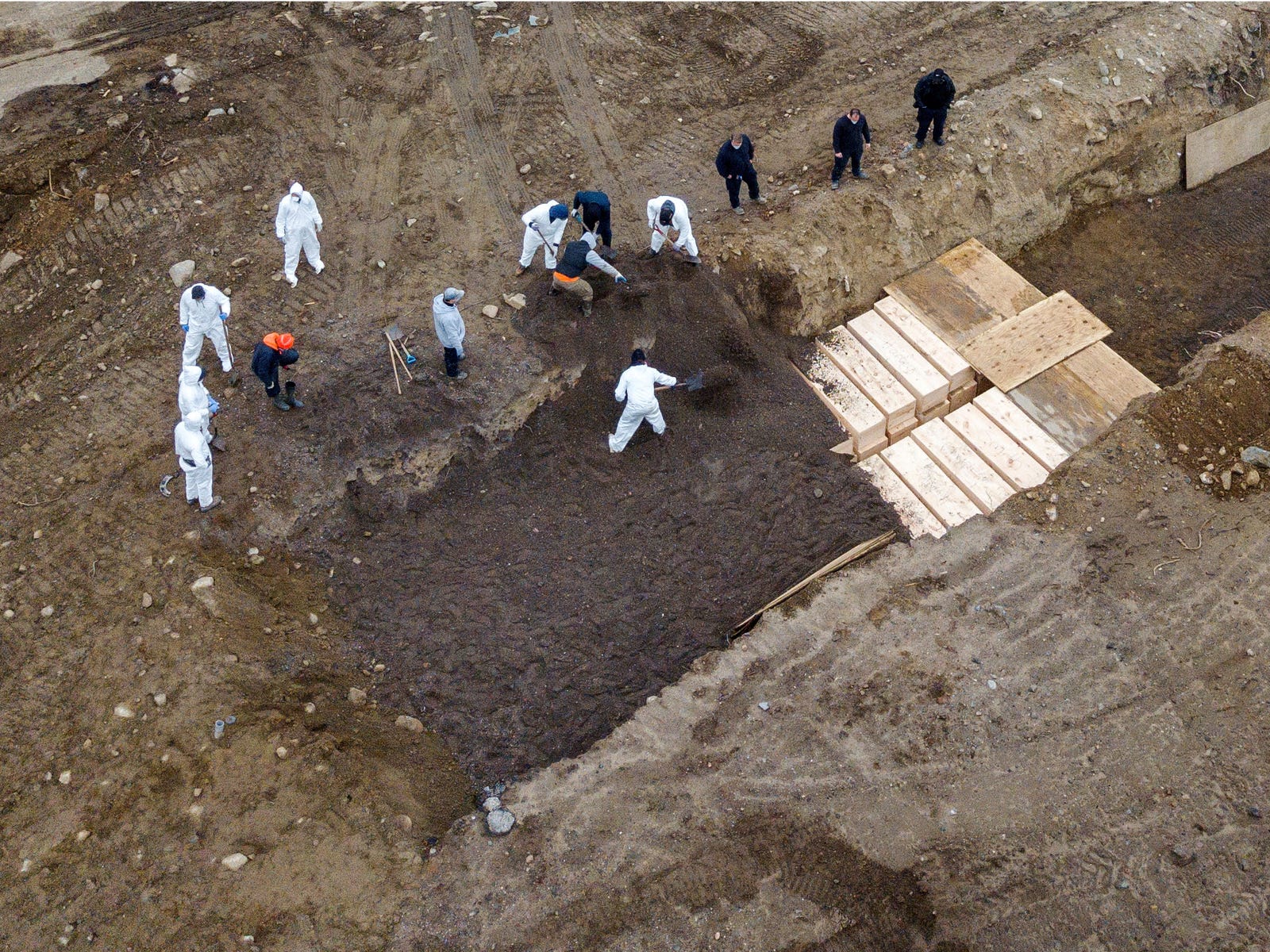 Workers employed by New York State bury the bodies of COVID-19 victims in a mass grave on Hart Island, off the coast of New York City.