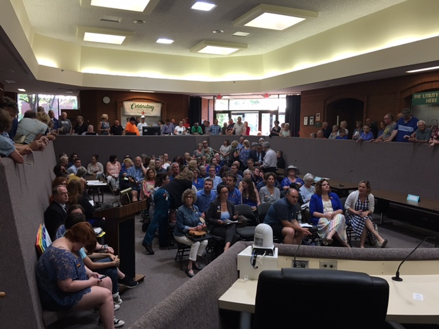 Crowd gathers to witness the passage of new laws banning discrimination based on a person's sexual orientation or gender identity.