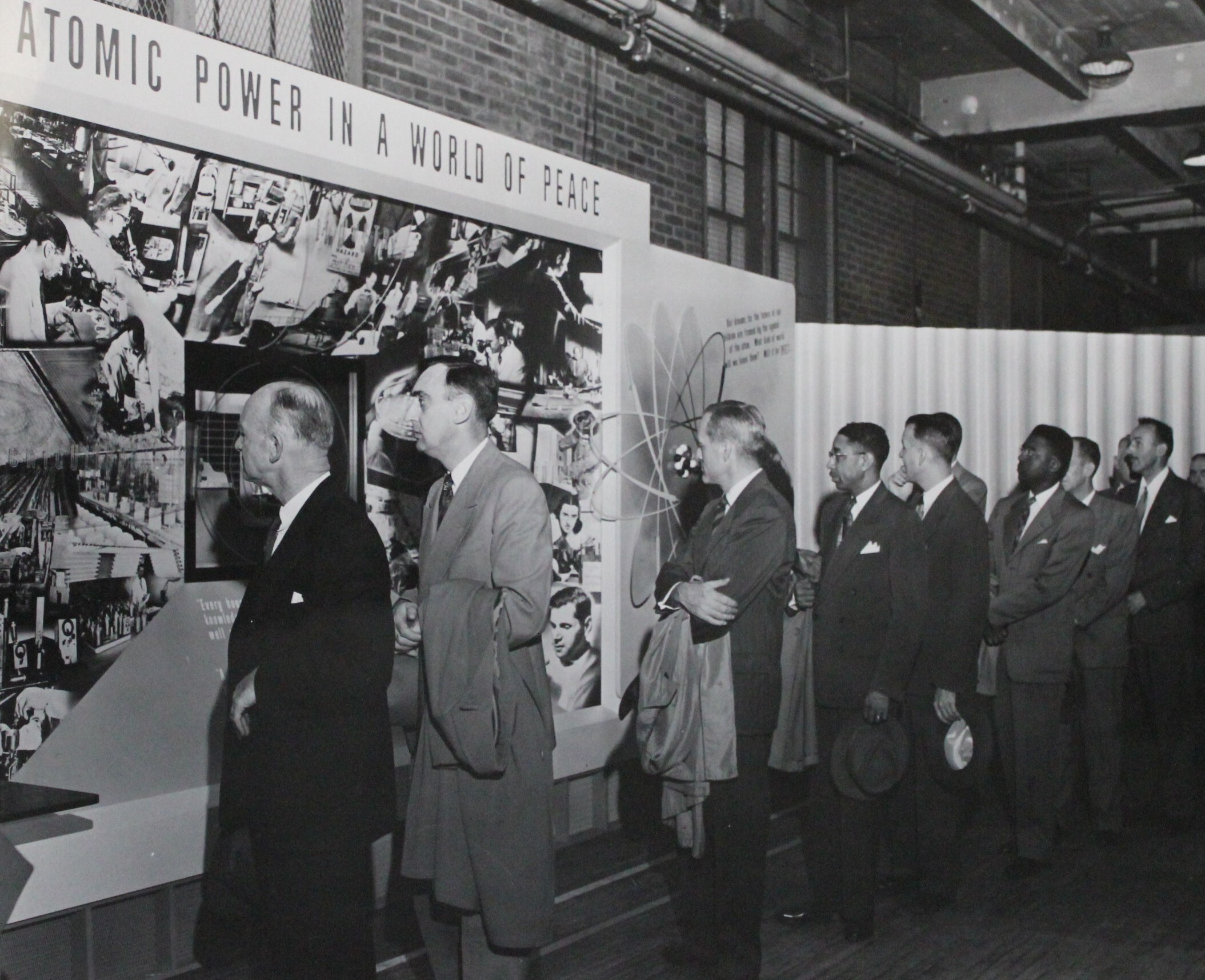Americans view an exhibit on atomic power.