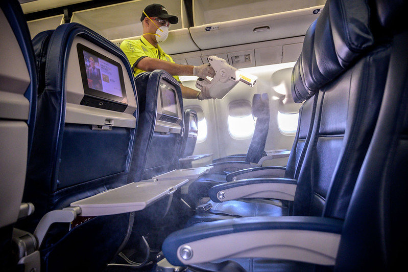 A Delta Airlines employee disinfects the surfaces of the cabin.