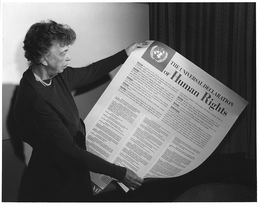 Eleanor Roosevelt holding a poster of the Universal Declaration of Human Rights.
