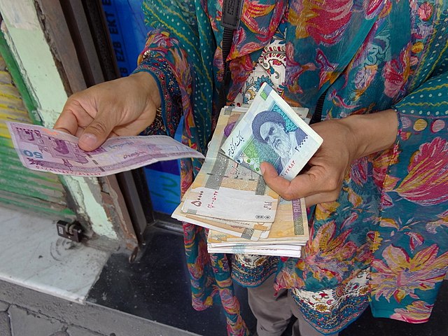 Tourist in 2012 holding Iranian currency (rial) in Ardabil, Iran.