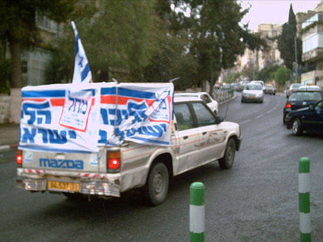 A truck covered in Likud banners.