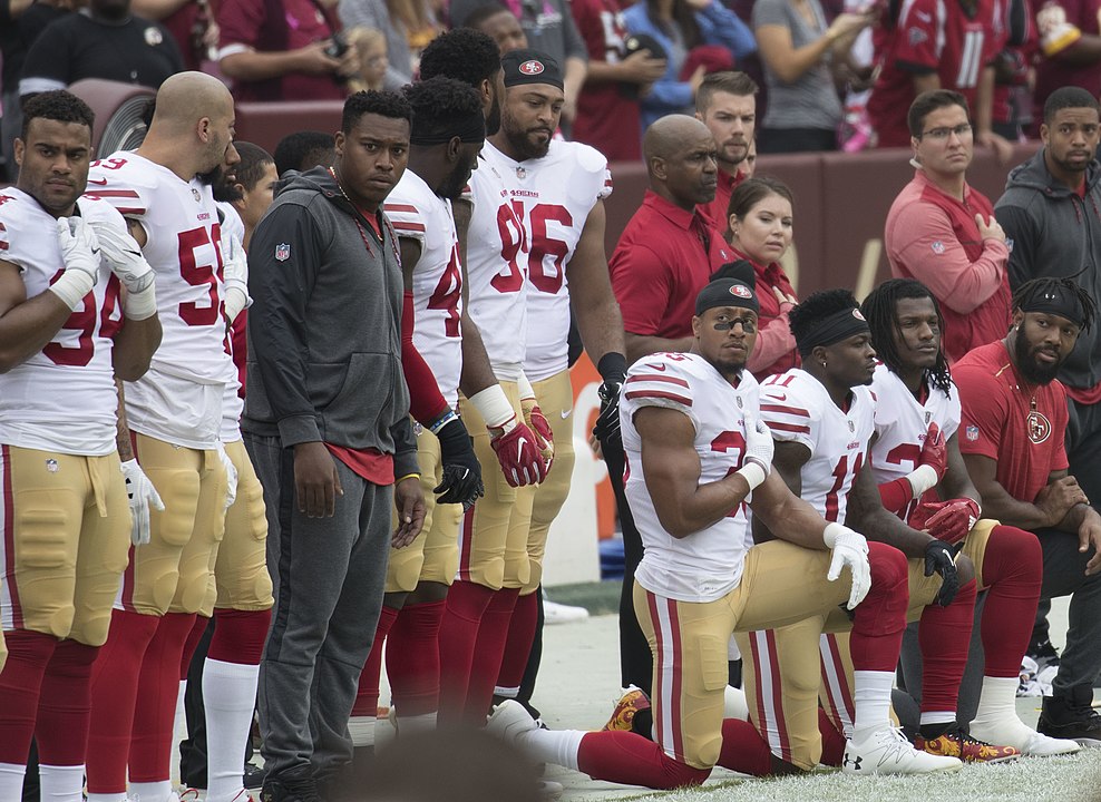 Members of the San Francisco 49ers kneel during the National Anthem before a game against the Washington Redskins, 2017